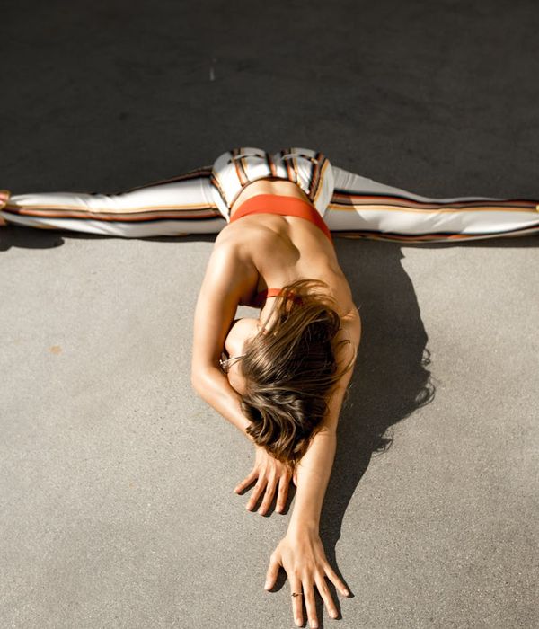Person demonstrating physical strength and flexibility in a yoga pose.
